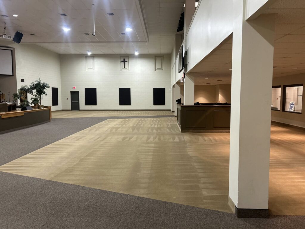 Professional carpet cleaner using steam cleaning machine for deep carpet cleaning